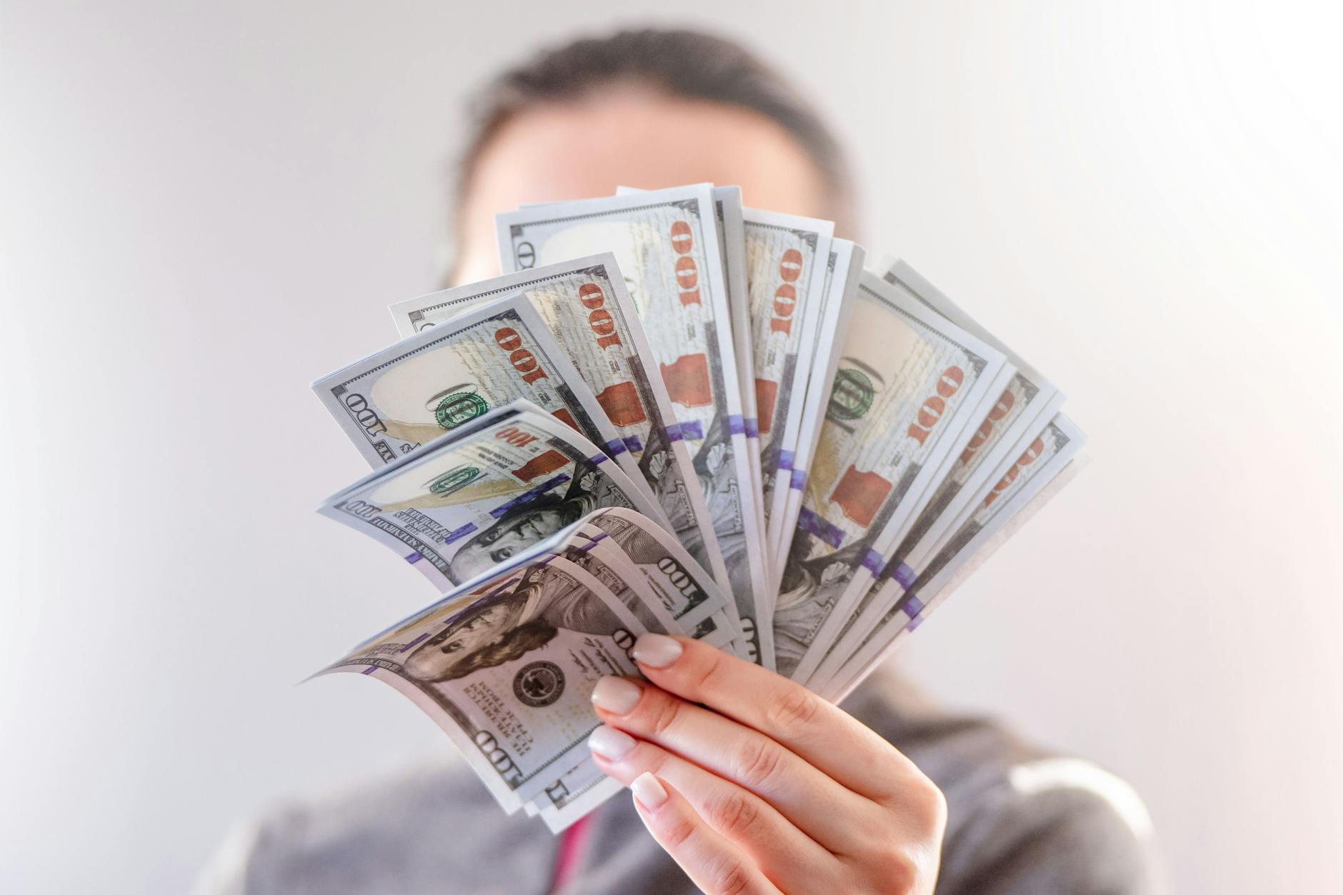 a person holding paper money