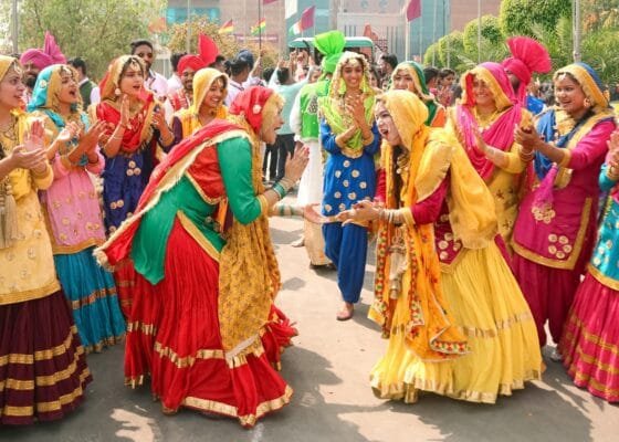 indian women in traditional clothing dancing in the street