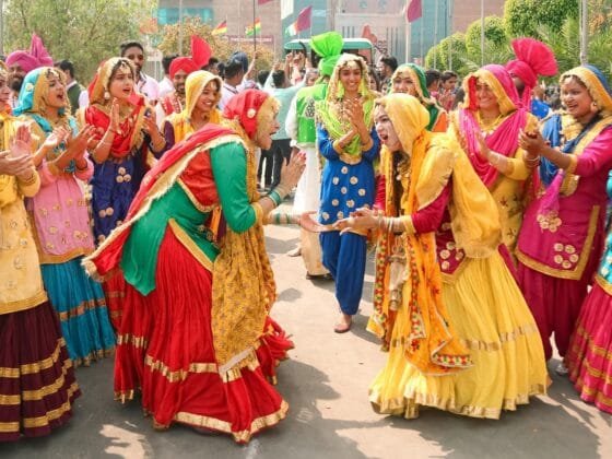 pexels-photo-23224411 | Beyond The Punchlines indian women in traditional clothing dancing in the street