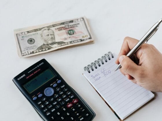 pexels-photo-4386339 | Beyond The Punchlines crop anonymous financier planning budget writing numbers in notebook